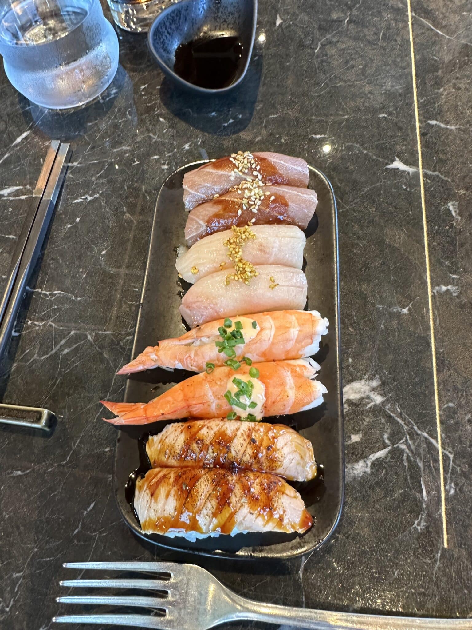 Beautifully presented nigiri sushi on dark marble at Sakura restaurant aboard Explora Journeys
